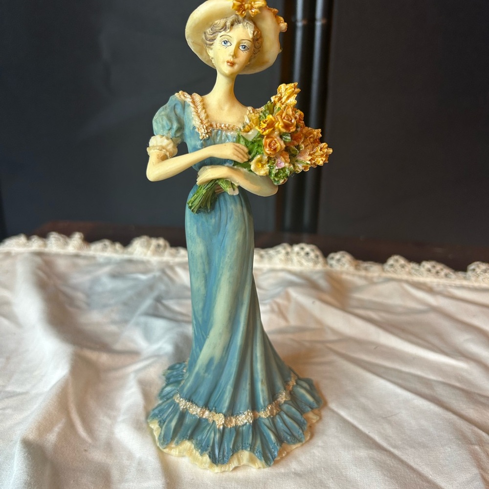 Elegant Blue Figurine with Yellow Flowers